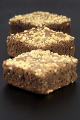 chocolate brownies with cracked peanuts on top