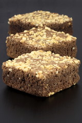 chocolate brownies with cracked peanuts on top