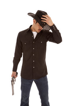 Cowboy holding hat and gun