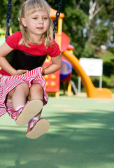 girl playing on playground - obrazy, fototapety, plakaty