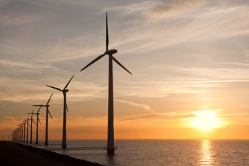 Wndturbines in the sea and a beautiful sunset