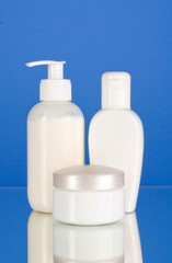 bottles of health and beauty products on blue background