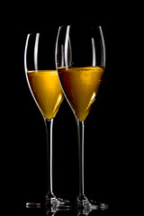 A glass of champagne, isolated on a yellow  background.