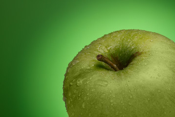 Green apple. Macro. on a green gradient