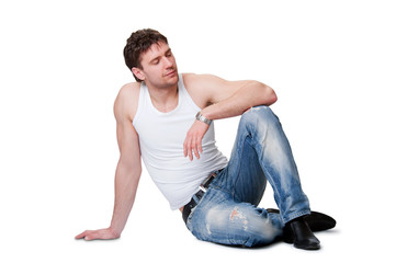 man in jeans sitting on an isolated background