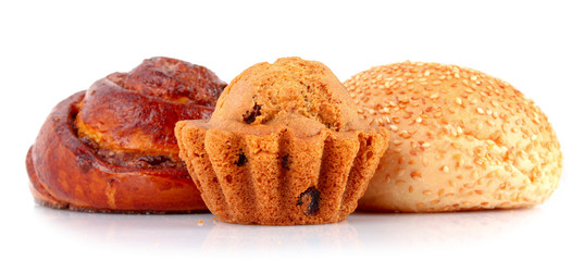 Loaf with raisins and muffin isolated on white