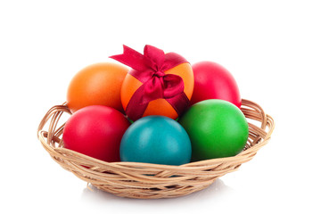 Easter eggs in basket isolated on white