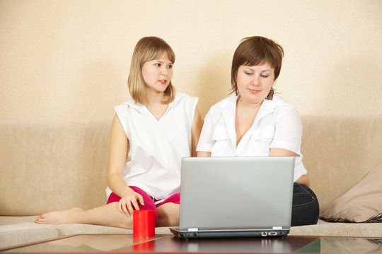 women sitting  with laptop
