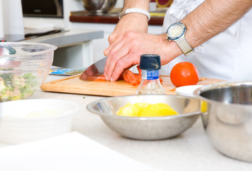 chef cutting the tomato