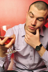 man with a glass of wine being thoughtful