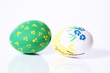 Two painted eggs green and white