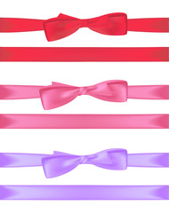 Red, pink and blue gift bows with ribbons.