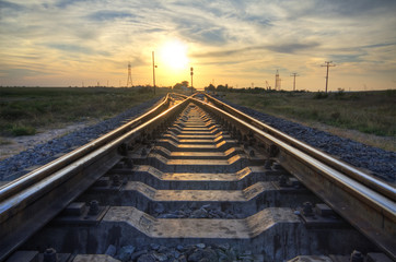 Railway going to horizon and bright sunset