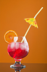 red coctail drink with ice cubs