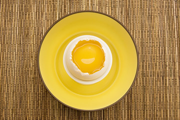 Yellow Egg Yolk in a Cracked Eggshell