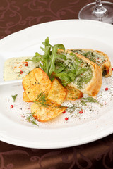 fish pie with sauce and potato chips