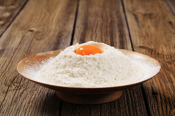 Fototapeta na wymiar Egg yolk and flour