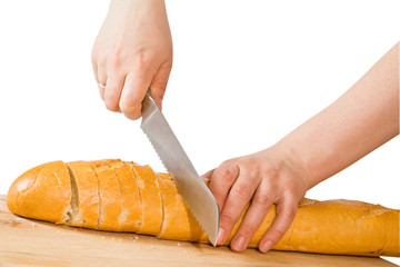 Hands cut bread