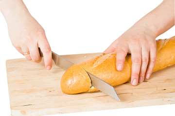 Hands cut bread