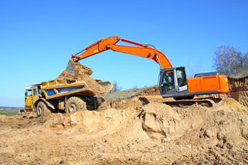 Obraz premium Backhoe loader loading dumper