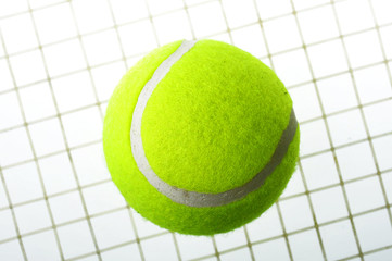 A tennis ball on net isolated on white background.