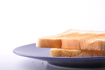 Two pieces of toast are on blue dish isolated on white backgroun