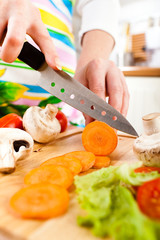 Woman's hands cutting vegetables