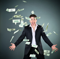 man in a suit throws money