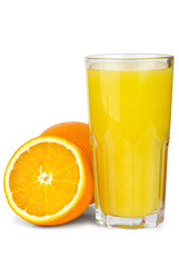 Drinking glass with orange juice and oranges near