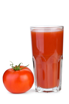 Drinking glass with tomato juice and ripe fresh tomato near