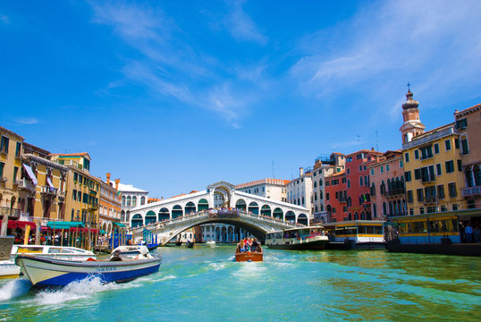 Venice Grand canal with gondolas and Rialto Bridge, Italy