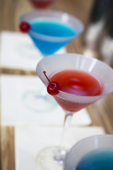 One blue cocktail martini  with cherry