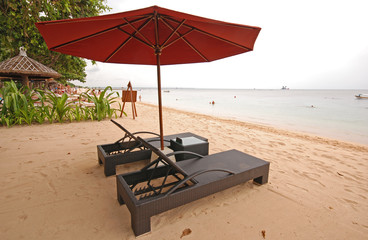 two chairs and umbrella on the beach