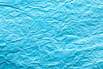 Image texture of crumpled blue paper.