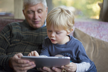 Grandfather and grandson using Tablet PC