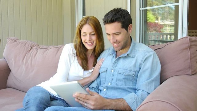 Young couple surfing on internet with touchpad