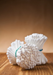 white cotton swabs on wooden background