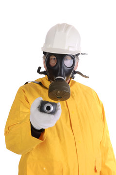 Man with geiger counter in gasmask and hazmat suit
