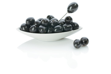 black olives on a plate with skewer
