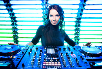 Attractive girl DJ in the nightclub