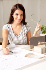 Architect with Blueprints and House Model