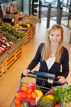 Portrait of woman holding shopping cart