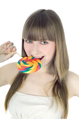 Bright picture of hungry blonde with color lollipop