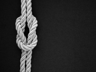White rope tie a knot on the black