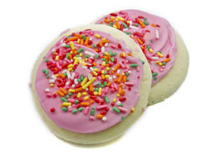 Two pink and sprinkles sugar cookies