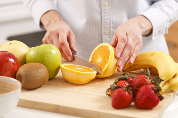 Woman cutting orange