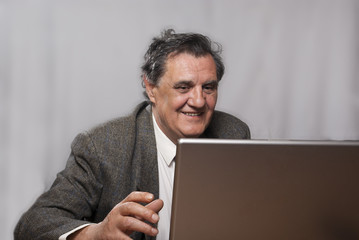 Happy successful business man with a laptop