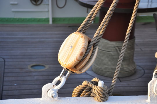 Old wooden pulley in a ship