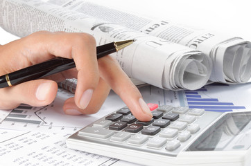 woman's hands with a calculator and a pen