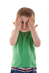 boy with his hands covering the eyes